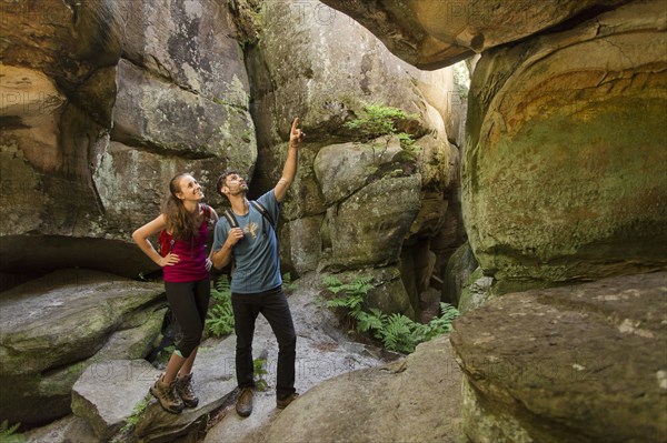 Caucasian couple exploring cave