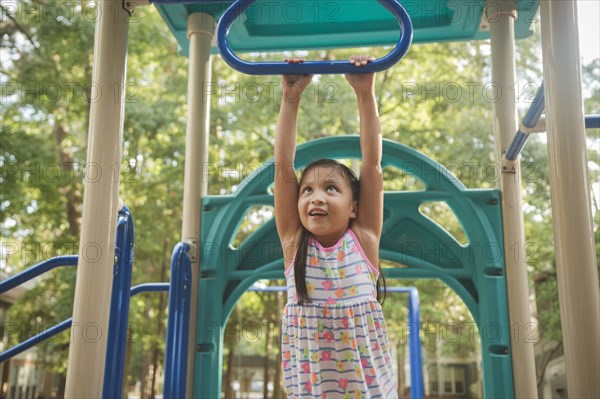 Hispanic playing on playground