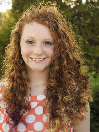 Portrait of smiling Caucasian girl with red hair