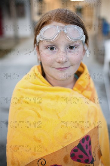 Portrait of Caucasian girl wrapped in towel after swimming