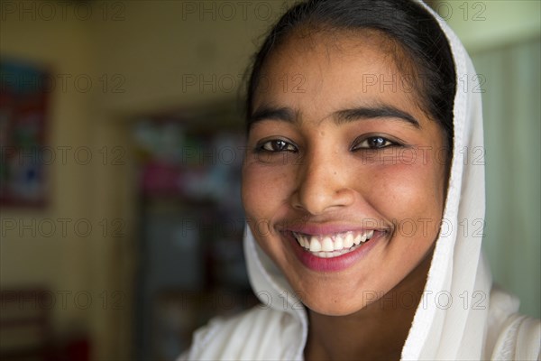 Close up of smiling girl wearing headscarf