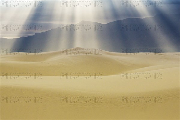 Sunbeams over sand dunes