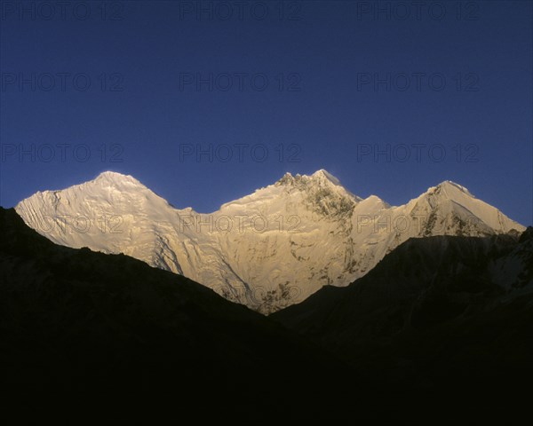 Snowy mountaintops under blue sky