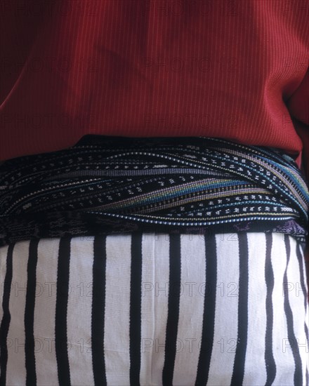 Close up of midsection of person wearing traditional clothing