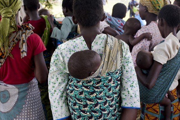 Mothers carrying children and waiting at rural health clinic