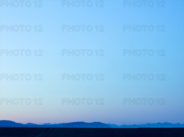 Silhouette of mountain range under blue sky