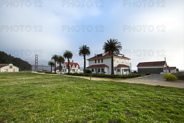 Houses and grass field near Golden Gate Bridge