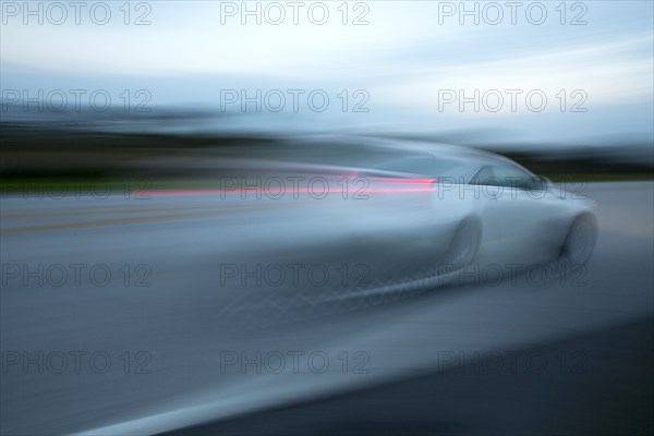 Blurred view of car driving on road
