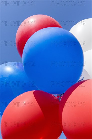 Low angle view of balloons under blue sky
