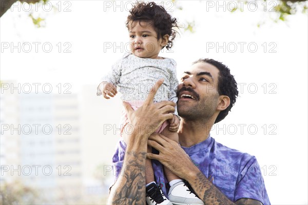 Father holding baby son outdoors