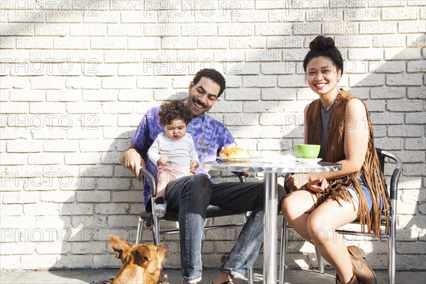 Parents eating with baby son at outdoor cafe