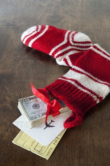 Christmas stocking with airline tickets and cash