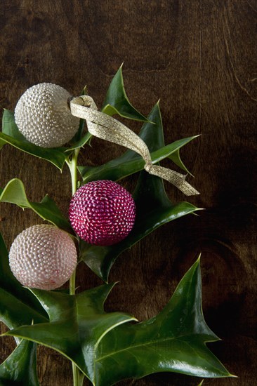 Close up of artificial berries on holly branch