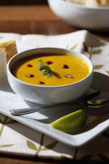 Curry soup in bowl with garnish