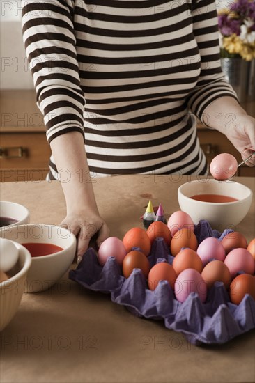 Woman dying Easter eggs