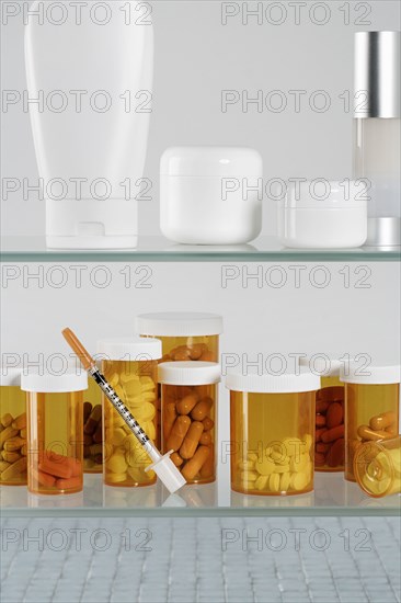 Medicine cabinet with  pill bottles and syringe