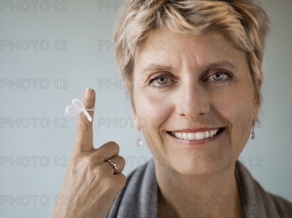 Caucasian woman with string tied on her finger