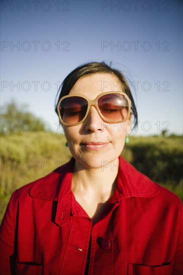 Smiling mixed race woman with eyes closed