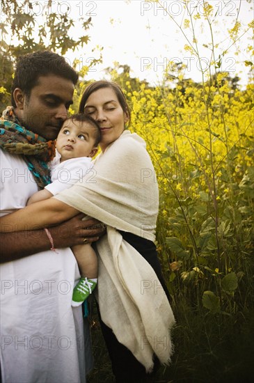 Family hugging in field