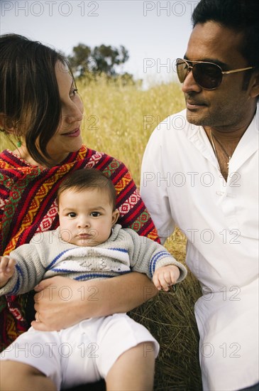 Family sitting together in field