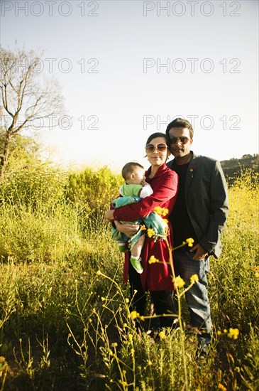 Family standing together in field