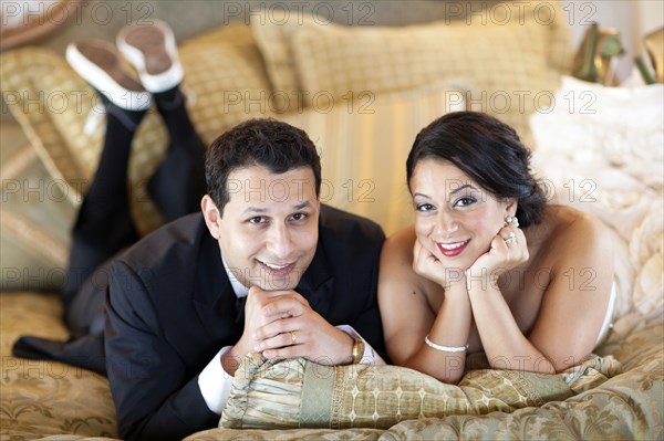 Egyptian bride and groom laying on bed