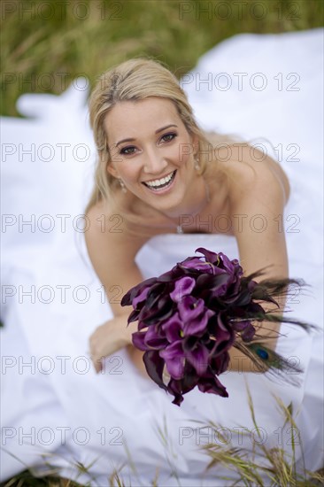 Hispanic bride holding bouquet of flowers
