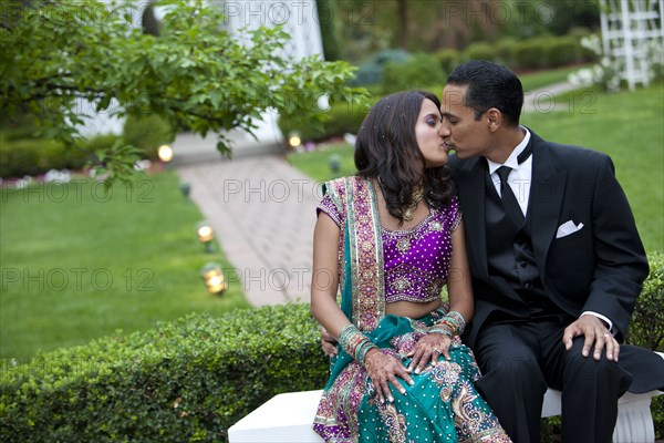 Indian couple in traditional clothing kissing