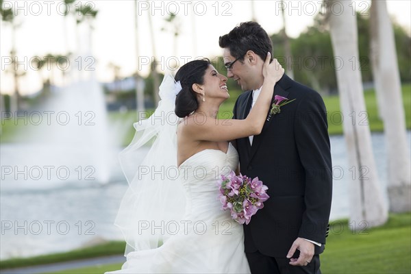 Newlywed couple smiling on golf course