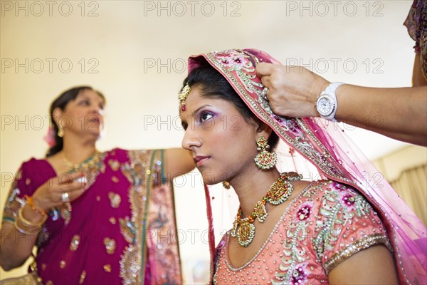 Indian bride wearing colorful fabrics and jewelry