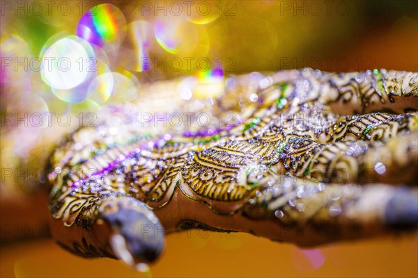 Close up of hand with intricate henna design