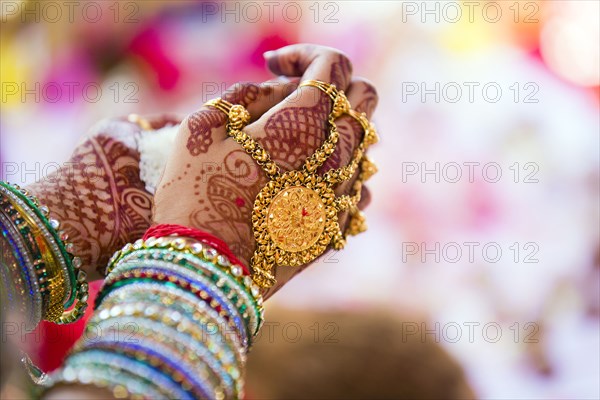 Close up of hands with intricate henna design