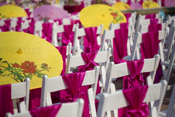 Parasols and silk scarves on chairs outdoors