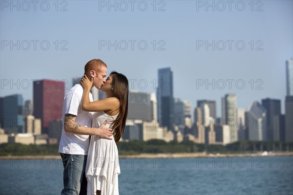 Couple kissing by Chicago skyline