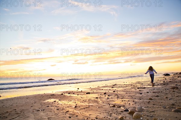 Caucasian woman walking on beach