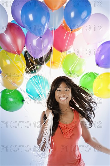 African American woman with birthday balloons