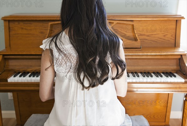 Mixed race woman playing piano