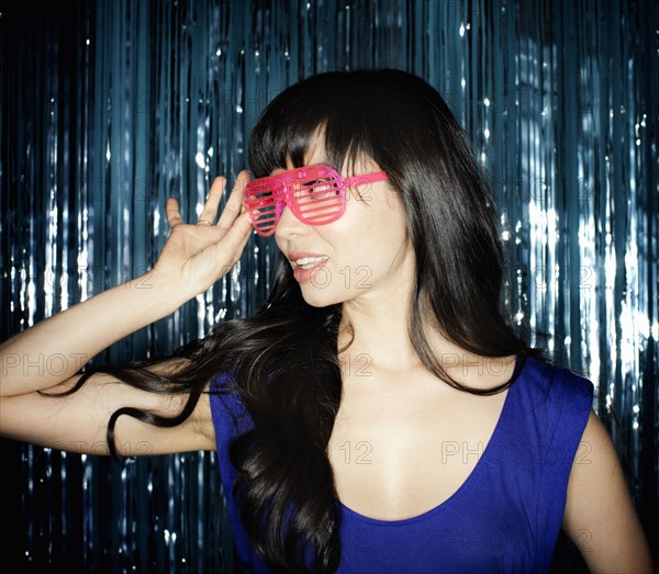 Glamorous mixed race woman in unusual sunglasses