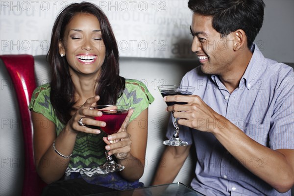 Couple drinking cocktails in nightclub