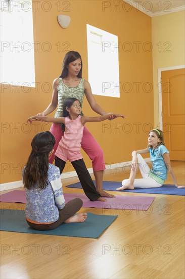 Teacher leading class of children in exercise routine