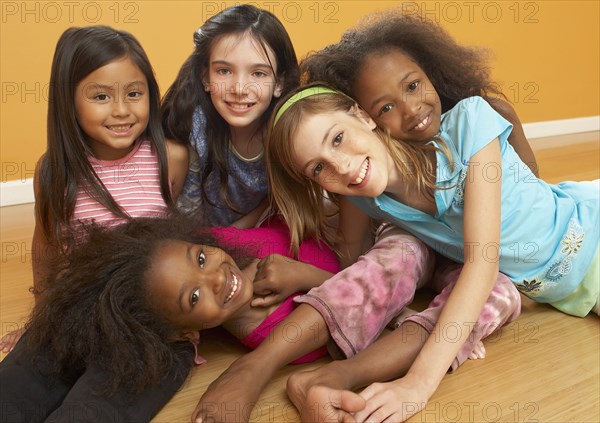 Children laying in pile and smiling