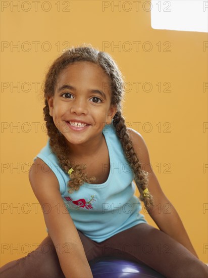 African girl sitting on exercise ball