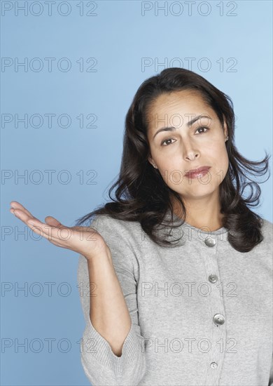 Skeptical Hispanic woman gesturing