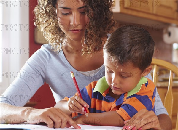 Mother helping son with homework