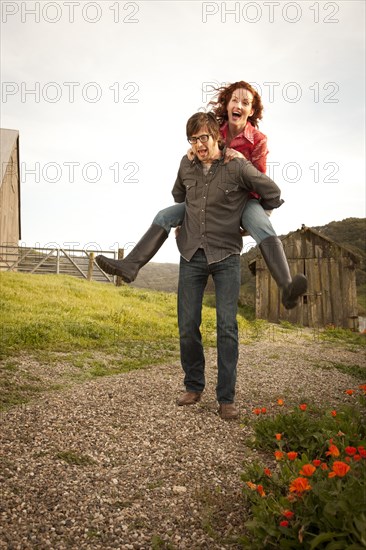 Couple playing in rural landscape