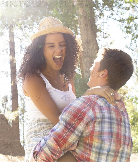 Couple playing in woods