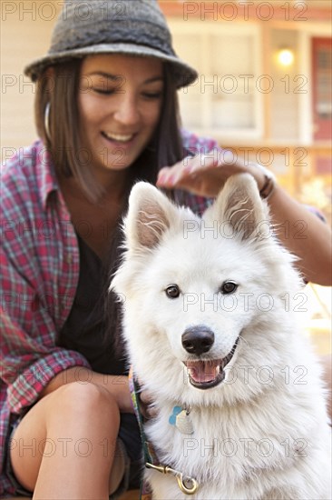 Woman petting dog outdoors