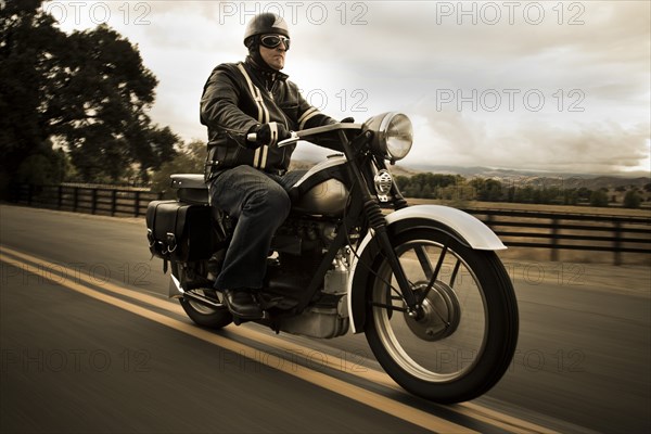 Man riding motorcycle on rural road