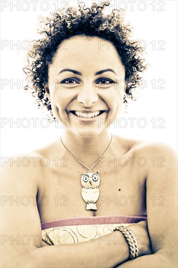 Close up portrait of smiling woman wearing owl necklace