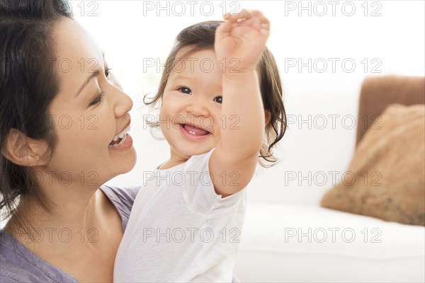 Mother playing with baby girl